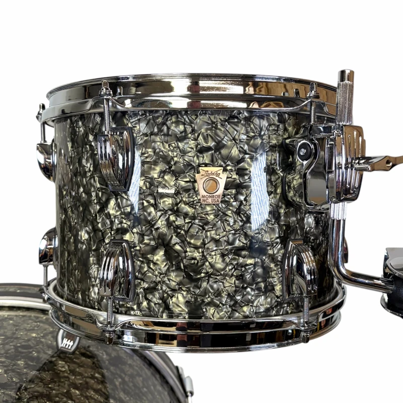 Pearl snare drum with a black and silver marbled finish, mounted on a drum kit.