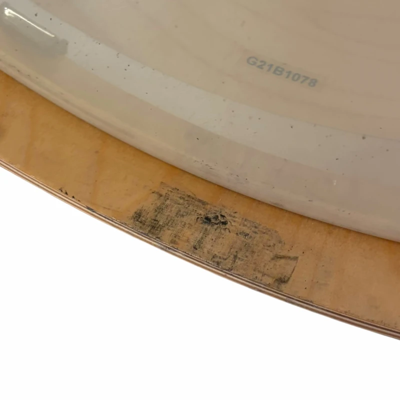 Vintage drum with visible scratches and worn surface, showcasing the craftsmanship of drumming equip.