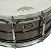 Close-up of SweetSpot steel snare drum with chrome finish and logo.