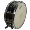 Black and chrome steel snare drum with drumsticks and strap.