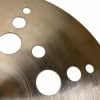Close-up of Istanbul Xist Ion 18in crash cymbal with holes and metallic finish.