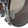 Close-up of a snare drum with mesh head and chrome hardware.