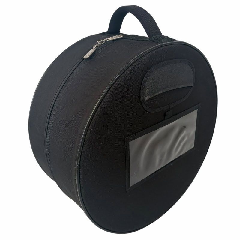 Black round snare drum case with handle and transparent pocket for accessories.