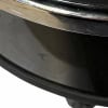 Close-up of a black drum with chrome rim, part of a drum kit setup.