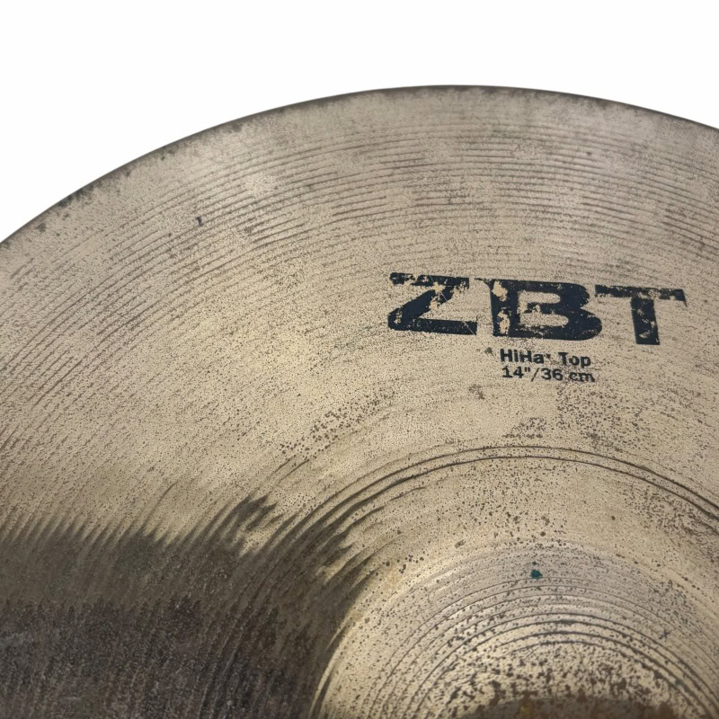 Close-up of Zildjian ZBT 14-inch hi-hat cymbals with logo visible.