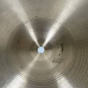 Close-up of a metallic cymbal with concentric circles and a central hole.