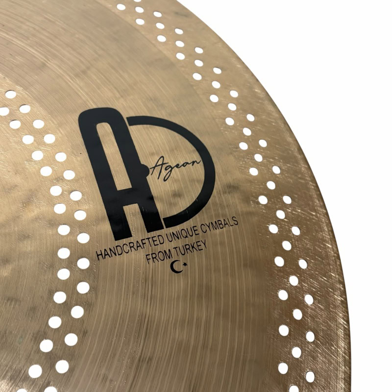 Close-up of Agen cymbal with perforations and logo.