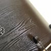 Close-up of black wood grain drum shell with Mapex logo.