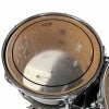Close-up of a used snare drum with scratches and marks.
