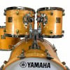 Yamaha Maple Custom 5-piece drum set with natural wood finish and chrome hardware.