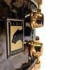 Close-up of Mapex Black Panther 14x6.5in hammered brass snare drum.