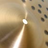 Close-up of a Meinl 20-inch hammered alloy crash cymbal with perforations.
