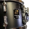 Black Sonor Momentum 22-inch drum shell with hardware details.