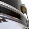 Close-up of a drum shell with rust and hardware details.