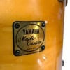 Yamaha Maple Custom drum shell with badge close-up.