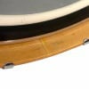 Close-up of Gretsch drum shell with wood finish and metal hardware.