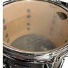 Close-up of a drum shell with visible scratches and hardware.