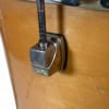 Close-up of drum hardware clamp on wooden drum shell.