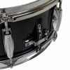 Close-up of a black snare drum with chrome hardware and a drumstick holder.