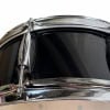 Close-up of a Gretsch snare drum with chrome hardware and black shell.