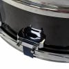 Close-up of Yamaha snare drum tensioner and drum shell.
