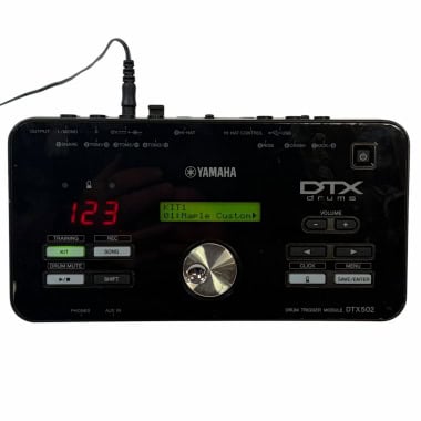 Yamaha DTX502 electronic drum module with display and control buttons.