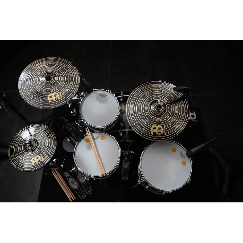 Drums and cymbals set with sticks viewed from above.