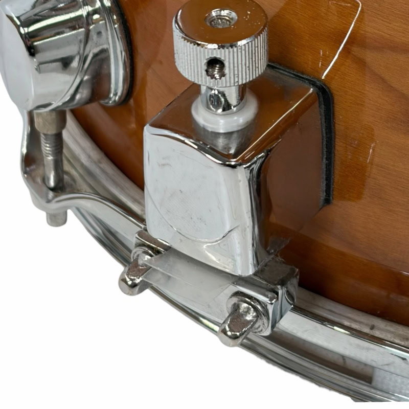 Close-up of Mapex Black Panther snare drum hardware and tuning mechanism.