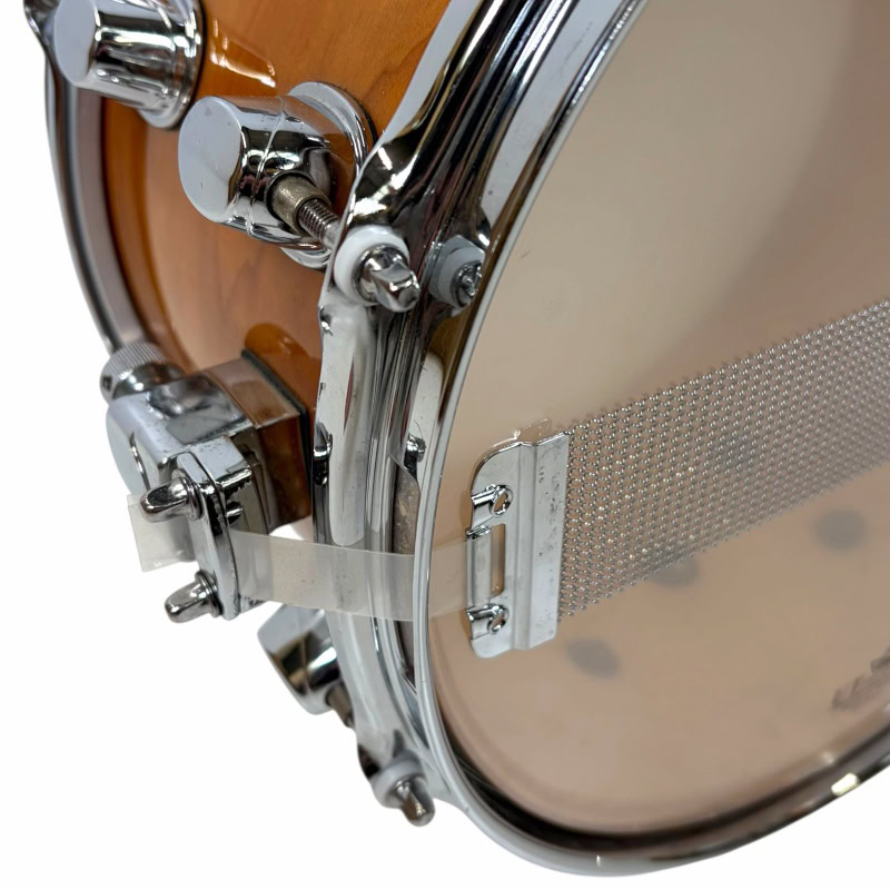 Close-up of Mapex Black Panther Cherry/Maple snare drum hardware and shell.