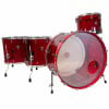 Red acrylic drum set with four shells and hardware for drumming.