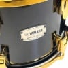 Close-up of Yamaha PHX 22in shell with Yamaha badge and gold hardware.