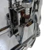 Close-up of chrome snare drum hardware and tension rods.