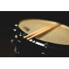 Pair of drumsticks resting on a snare drum for percussion performance.