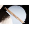 Drumsticks resting on a snare drum for Meinl Alex Rudinger signature series.