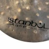 Close-up of Istanbul Agop 17in Dark Dry Hats cymbal with logo.