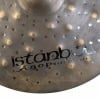 Close-up of Istanbul Agop 17in Dark Dry Hats cymbal with logo and perforations.