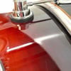 Close-up of a drum shell with a glossy finish and hardware details.
