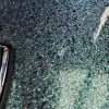 Close-up of textured drum shell surface with glittery finish.