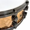 Close-up of Mapex Black Panther 14x5.5in snare drum with hammered bronze finish.