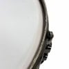 Close-up of a snare drum with a white drumhead and black hardware.