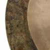Close-up of a vintage sand finish ride cymbal with patina and wear marks.