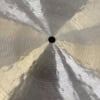 Close-up of a shiny cymbal with reflections and concentric circles.