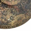 Close-up of a rusted crash cymbal with textured surface.