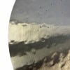 Close-up of a hammered crash cymbal with water droplets and reflections.