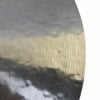 Close-up of a hammered Meinl Byzance Traditional 20in crash cymbal with water droplets.