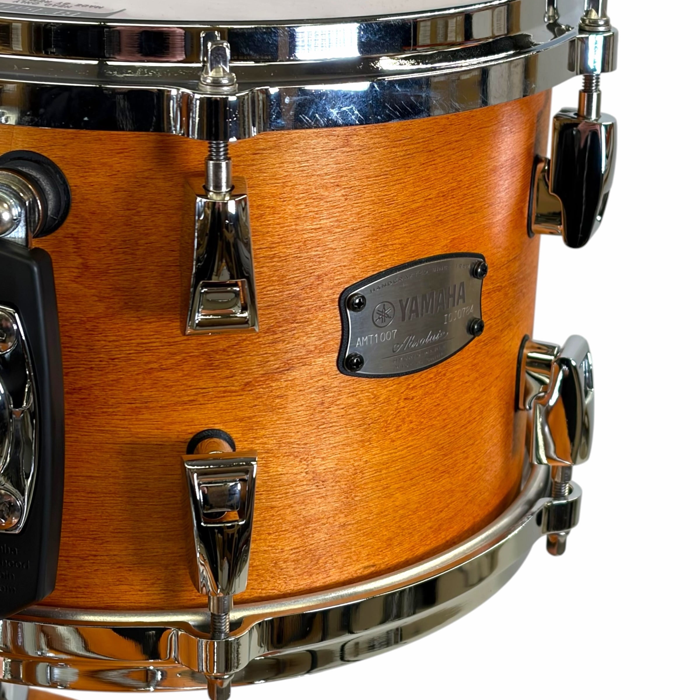 Close-up of Yamaha drum shell with wood finish and hardware.