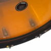 Close-up of orange Ludwig Vistalite drum shell with chrome lugs and badge.