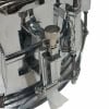 Close-up of chrome drum hardware on a snare drum.