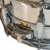 Close-up of chrome drum hardware and lugs on a Ludwig Vistalite snare.