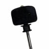 Compact black microphone windscreen on a stand, close-up.